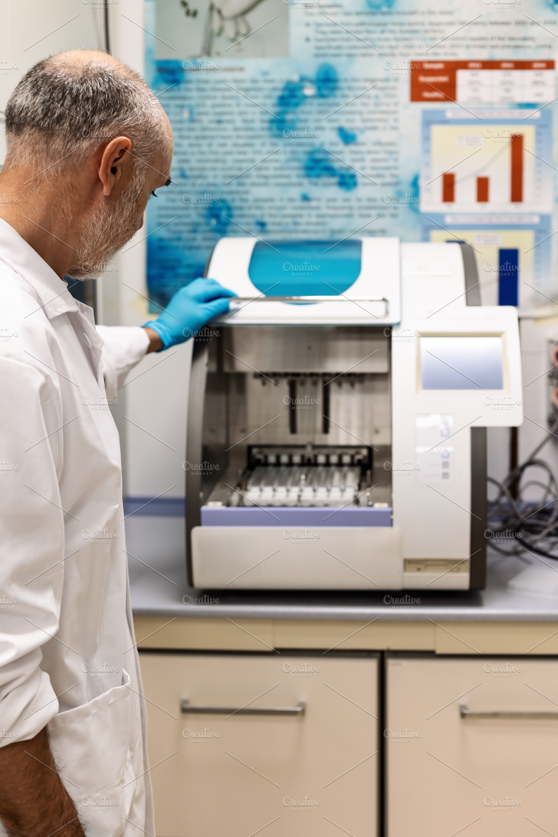 Scientist operating an automated sam, a Health & Medical Photo by Perpis