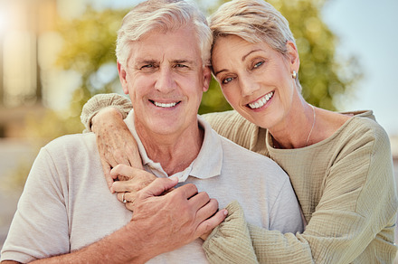 Portrait, love and retirement with a senior couple hugging outdoor in nature together during summer. Happy, smile and park with an elderly man and woman pensioner bonding outside on a romantic date, a Photo by Peopleimages.com