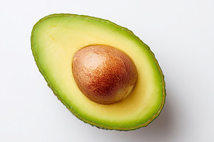 Fresh avocado half with vibrant green flesh and smooth brown pit displayed on a, a Food & Drink Photo by AlyaAnd