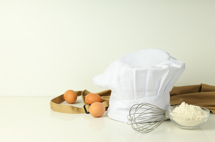 Composition with chef hat for concept of cooking, space for text, a Food & Drink Photo by AtlasStudio PRO