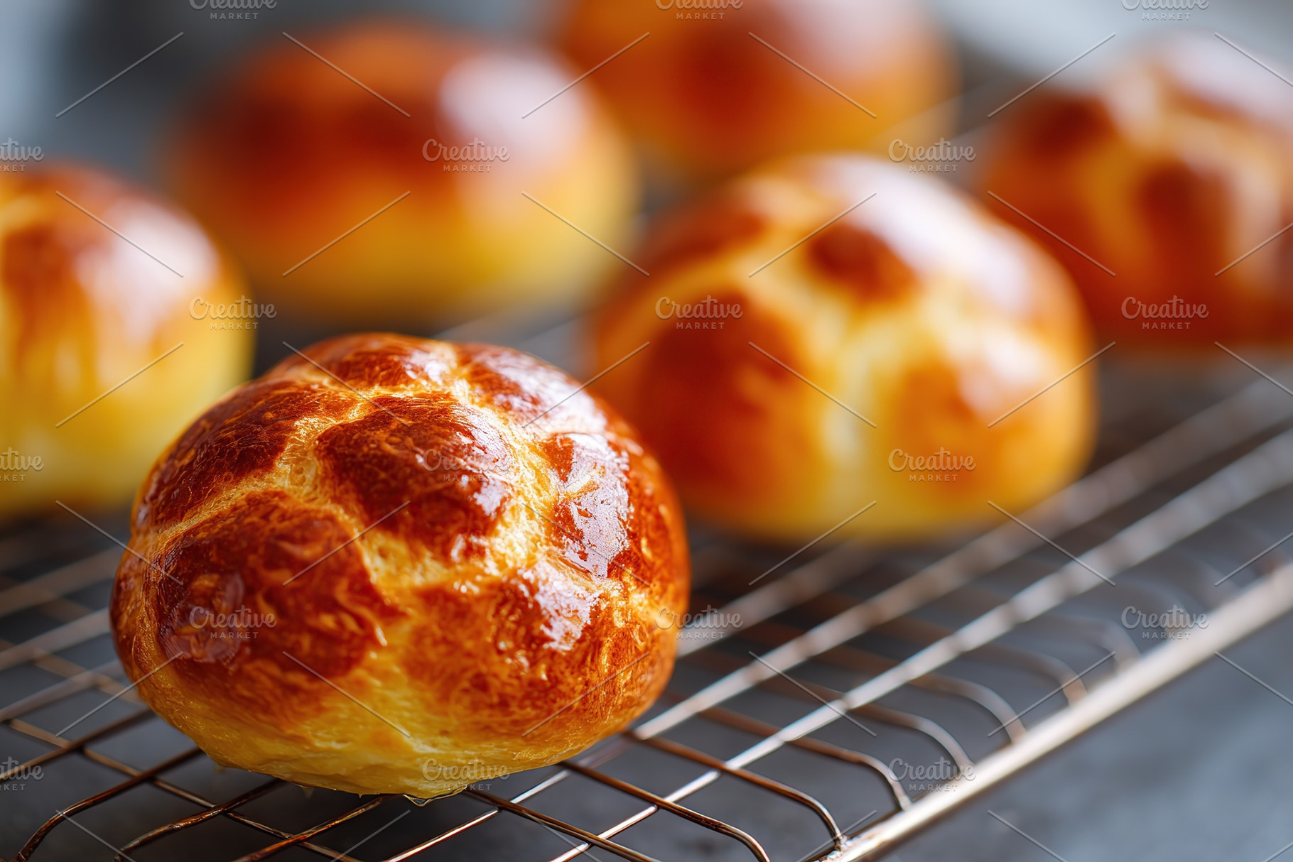 Freshly baked brioche buns with a glossy egg wash cooling on a wire rack in a c, a Food & Drink Photo by AlyaAnd