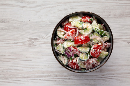 Homemade Tomato Cucumber Feta Salad in a Bowl, top view. Flat la, a Food & Drink Photo by LiudmylaChuhunova