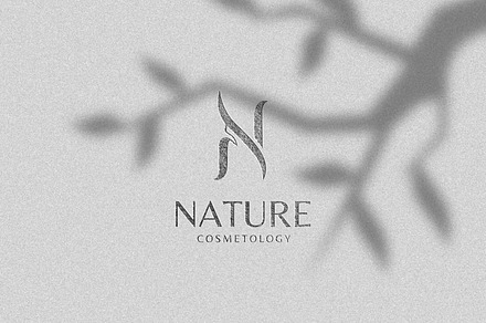 N initial with lady silhouette