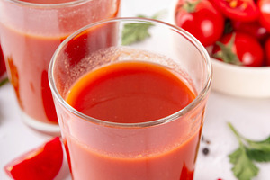 Tasty salted tomato juice in two glasses with fresh ripe tomatoe, a Food & Drink Photo by Rimma