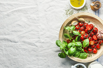 Tomatoes and basil in wooden bowl, a Food & Drink Photo by VICUSCHKA