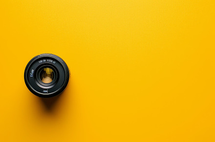 A detailed view of a camera lens pos, a Photo by Tanuart