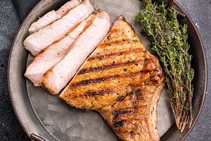 Flavorful grilled pork loin chop with bone, expertly cooked to p, a Food & Drink Photo by composter-box@mail.ru
