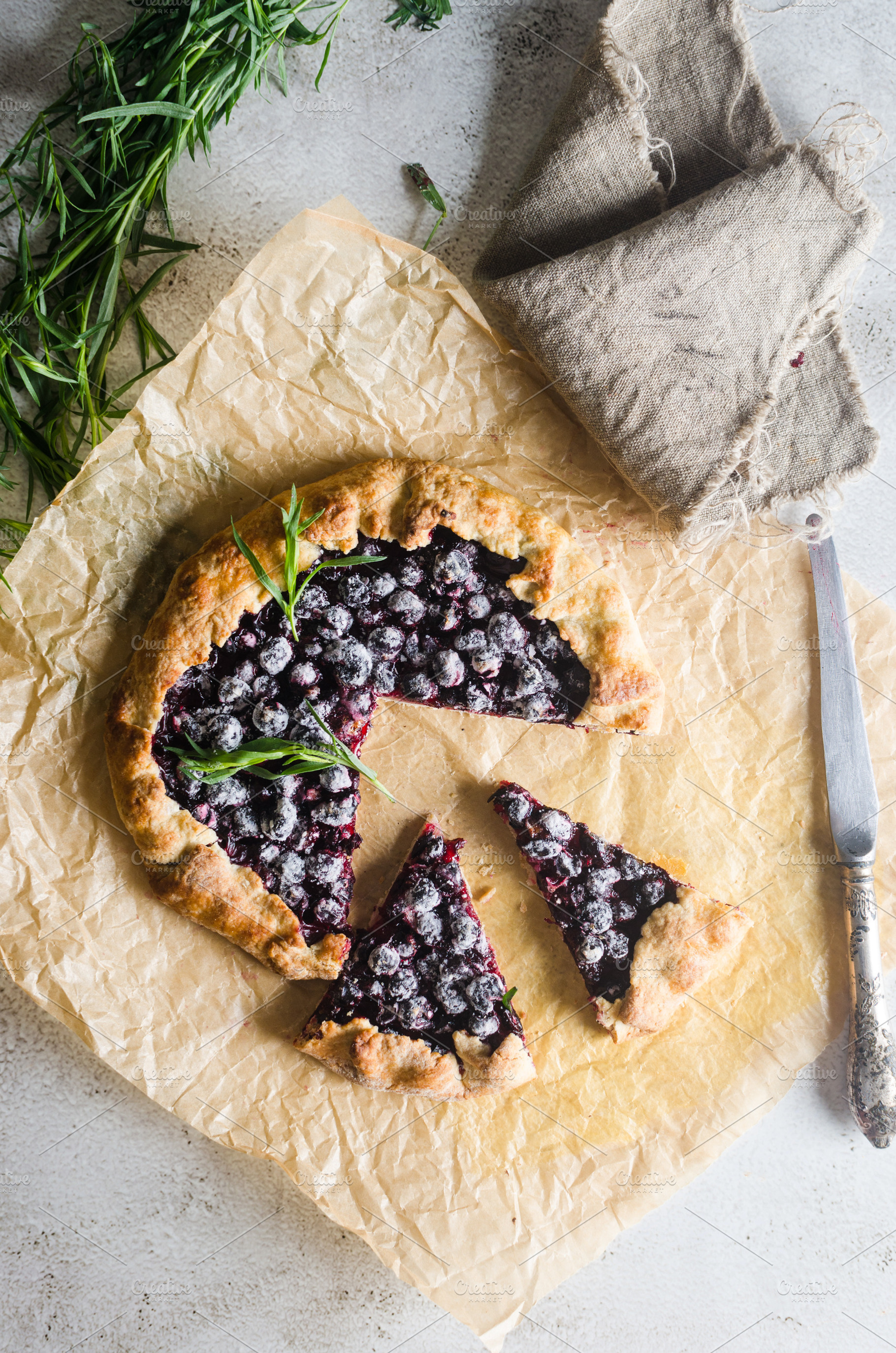 Homemade blackcurrant galette on old concrete background., a Food & Drink Photo by vimart