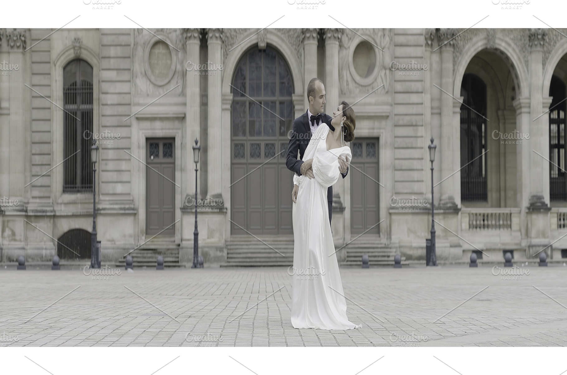 A tall couple in suits posing in the, a Person Photo by Media Whale Stock