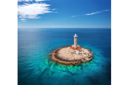 Lighthouse on smal island in the sea, an Architecture Photo by den-belitsky