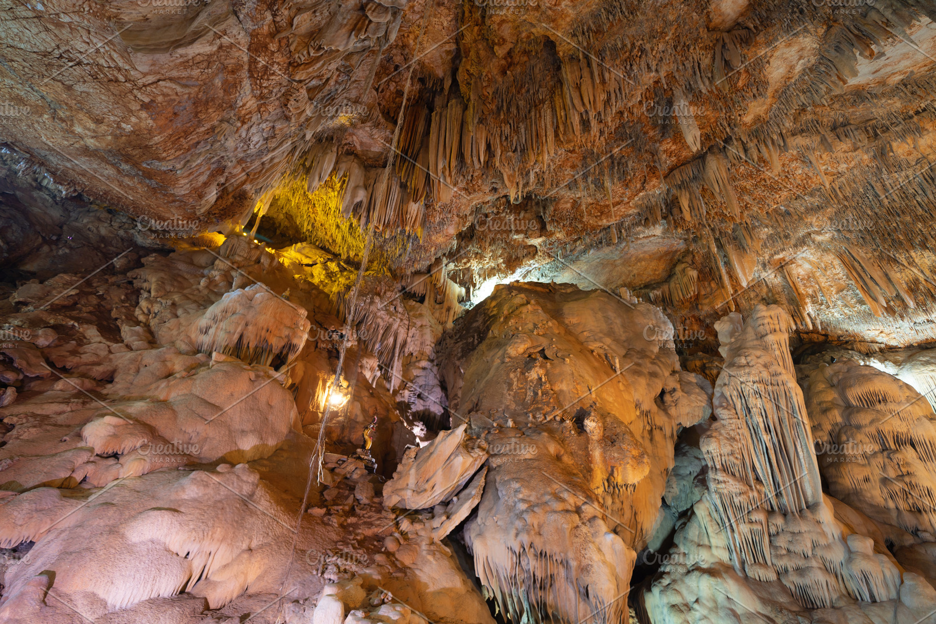 Natural stalactite and stalagmite rock stone cliff hang from cav, a Background Photo by Tampatra