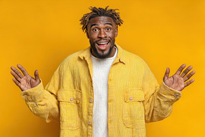 Cheerful man in bright yellow jacket smiling with surprise and e, a Person Photo by José Manuel Gelpi