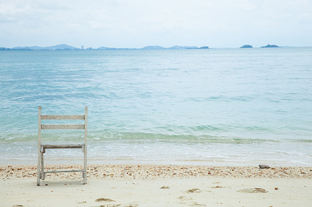 White wooden chair featuring bay, beach, and calm, an Abstract Photo by a454