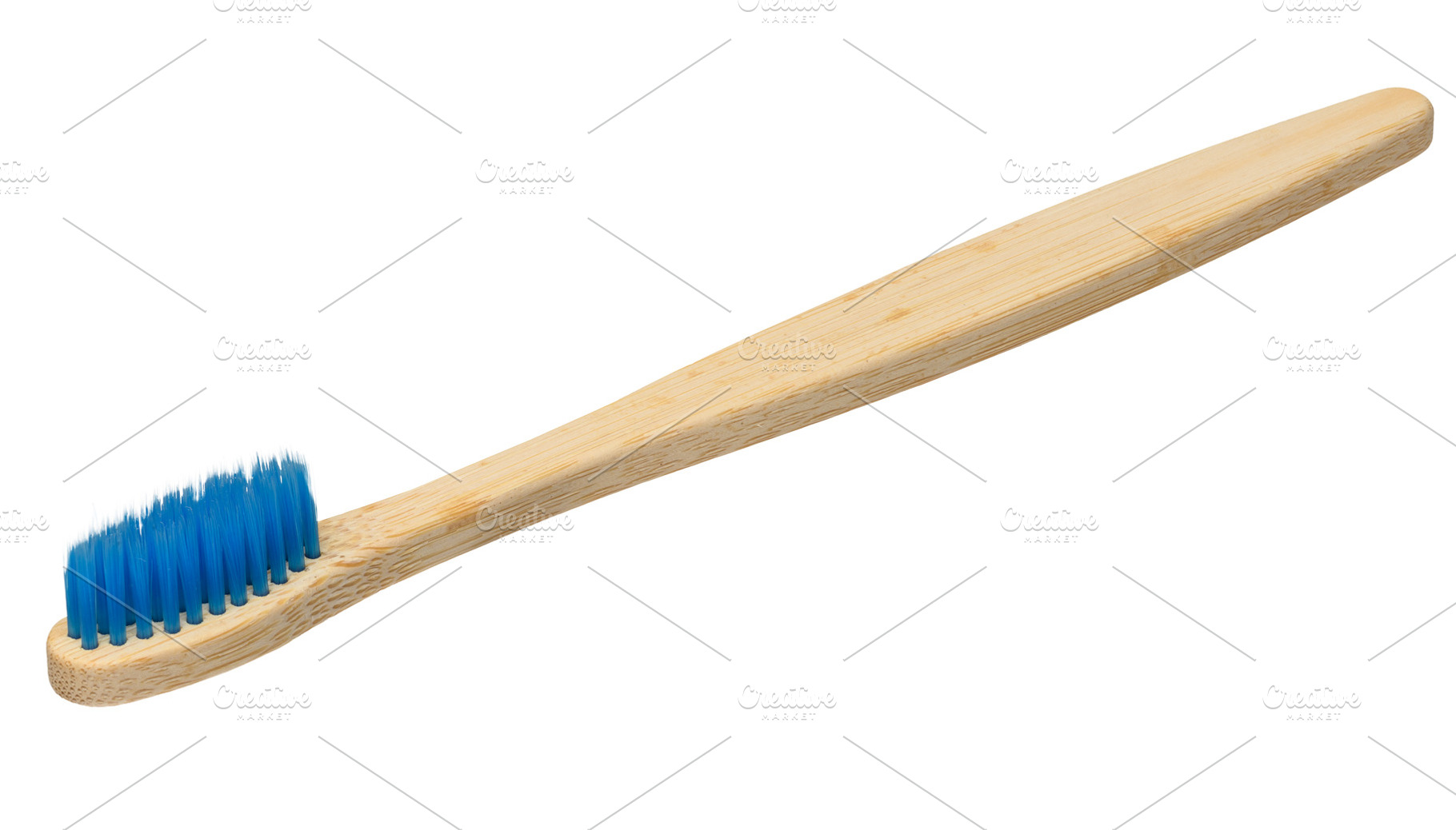 Bamboo toothbrush with blue bristles isolated on background. Clo, a Health & Medical Photo by ndanko