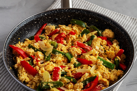 Homemade Scrambled Peppers and Eggs in a Pan, side view., a Food & Drink Photo by LiudmylaChuhunova