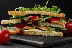 A delicious multi-layered sandwich with grilled chicken, fresh t, a Food & Drink Photo by ndanko