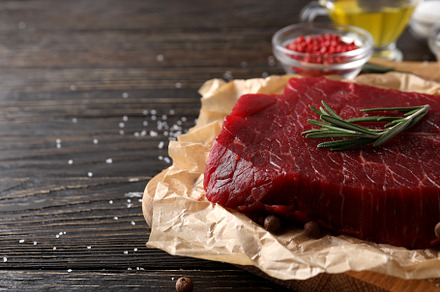 Concept of tasty food with raw beef steak on wooden background, a Food & Drink Photo by AtlasStudio PRO