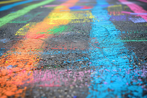 A Vibrant Street Scene Featuring Colorful Chalk Drawings On Asphalt. The Artwor