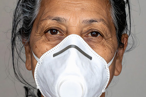Senior woman wearing white protective breathing mask, a Health & Medical Photo by GoodGoods