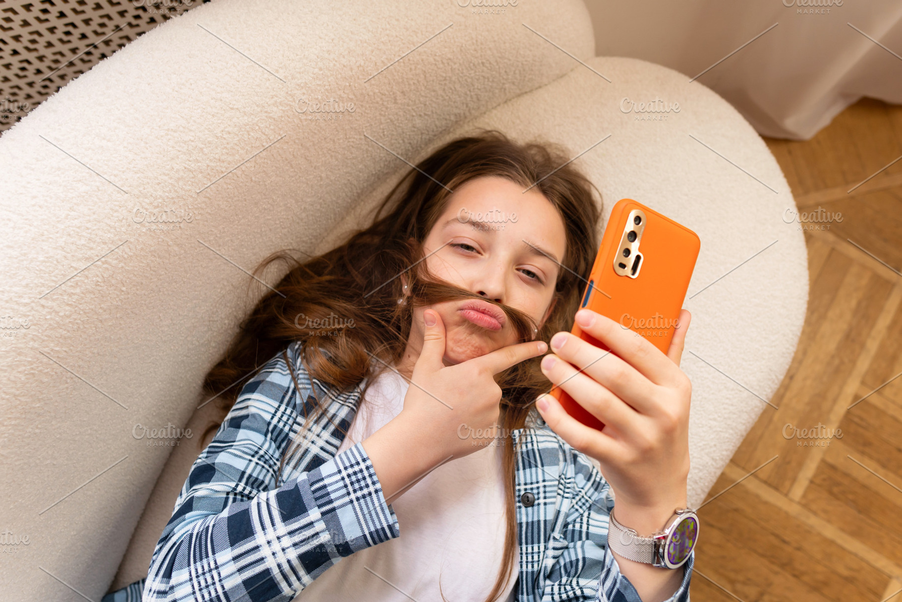 Girl taking playful selfie with hair, a Person Photo by Elena Vagengeim