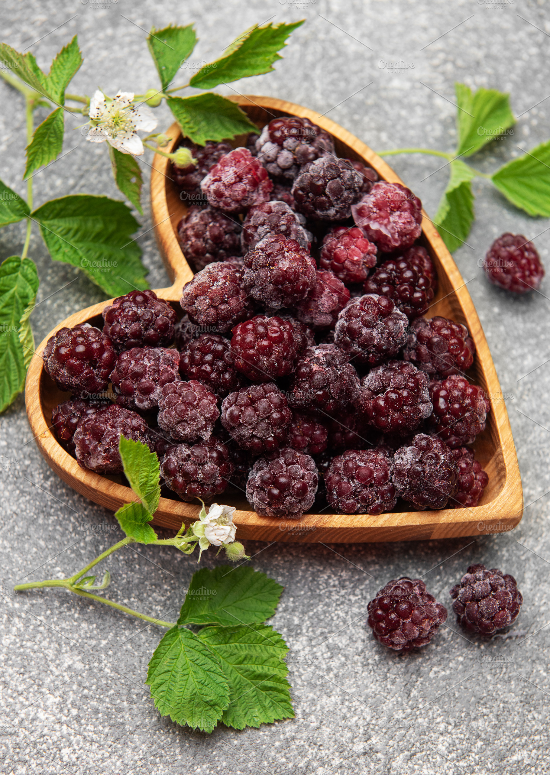 Frozen blackberries in heart shaped wooden bowl, a Food & Drink Photo by Olena Rudo