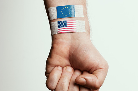 Hand with Bandaged Flags of USA and EU, a Business Photo by Alliance Images