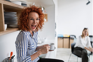 Mature businesswoman on coffee break, a Business Photo by HalfPoint