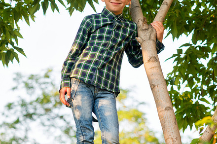 Boy relaxing on tree branch, a Person Photo by Elena Vagengeim