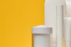 Set of white cosmetic packaging without brand on yellow backgrou, a Beauty & Fashion Photo by ndanko