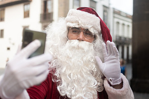 Santa Claus making video call and waving with smartphone, a Holiday Photo by etorres69