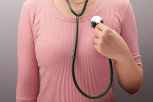 Woman touching chest with heart and stethoscope symbol. Self awa, a Photo by salmon.black