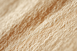 Close-up view of a blank textured page showcasing natural fibers and warm tones, a Background Photo by AlyaAnd