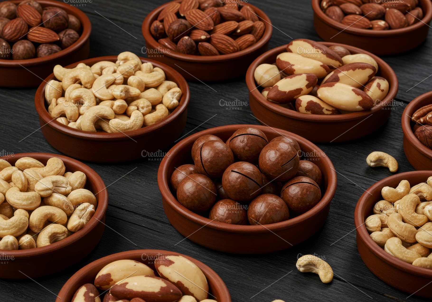 Assorted mixed nuts in rustic clay b, a Food & Drink Photo by professorinc