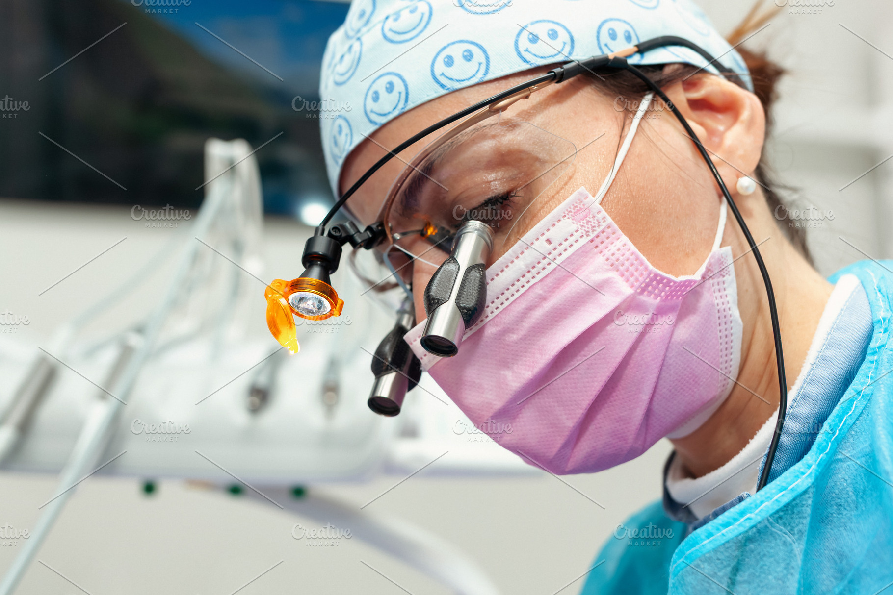 Dentist wearing magnifying glasses and mask performing dental checkup, a Photo by Antonio Gravante Market