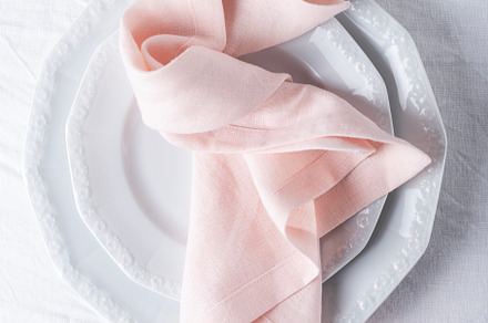 Pink linen napkins on the white table