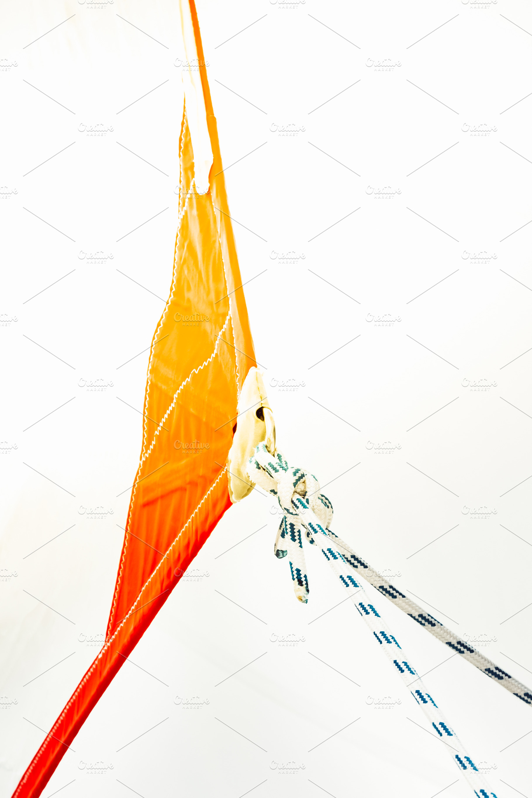 Sailing boat ropes tied to an orange, a Photo by Dvoevnore photos