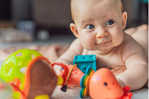 Little baby playing with toys on a, a Person Photo by Elizaveta Galitskaya