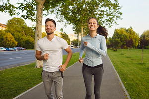 Couple Jogging Along City Street, a Person Photo by StudioRomantic