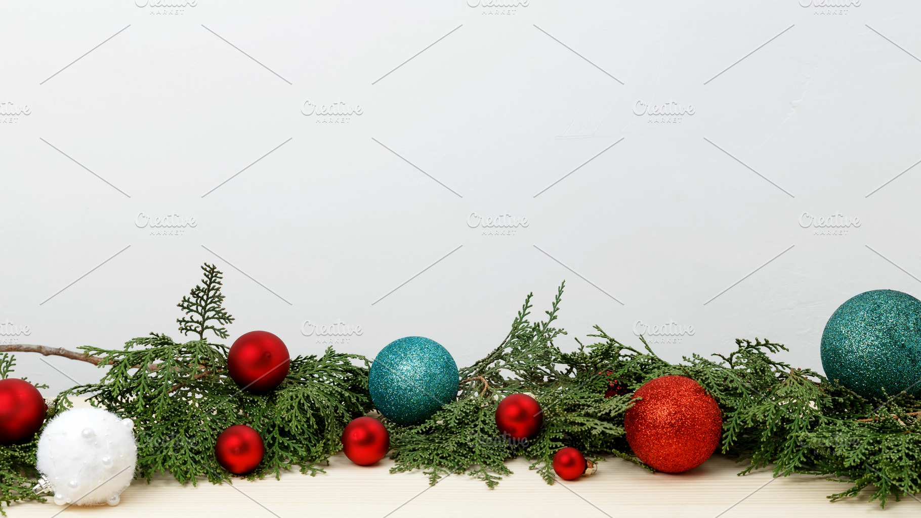 Creating a festive atmosphere, thuja branches and Christmas ornaments on a wood, a Photo by matucha
