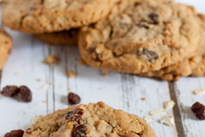 Fresh oatmeal raisin cookies featuring baked, board, and brown