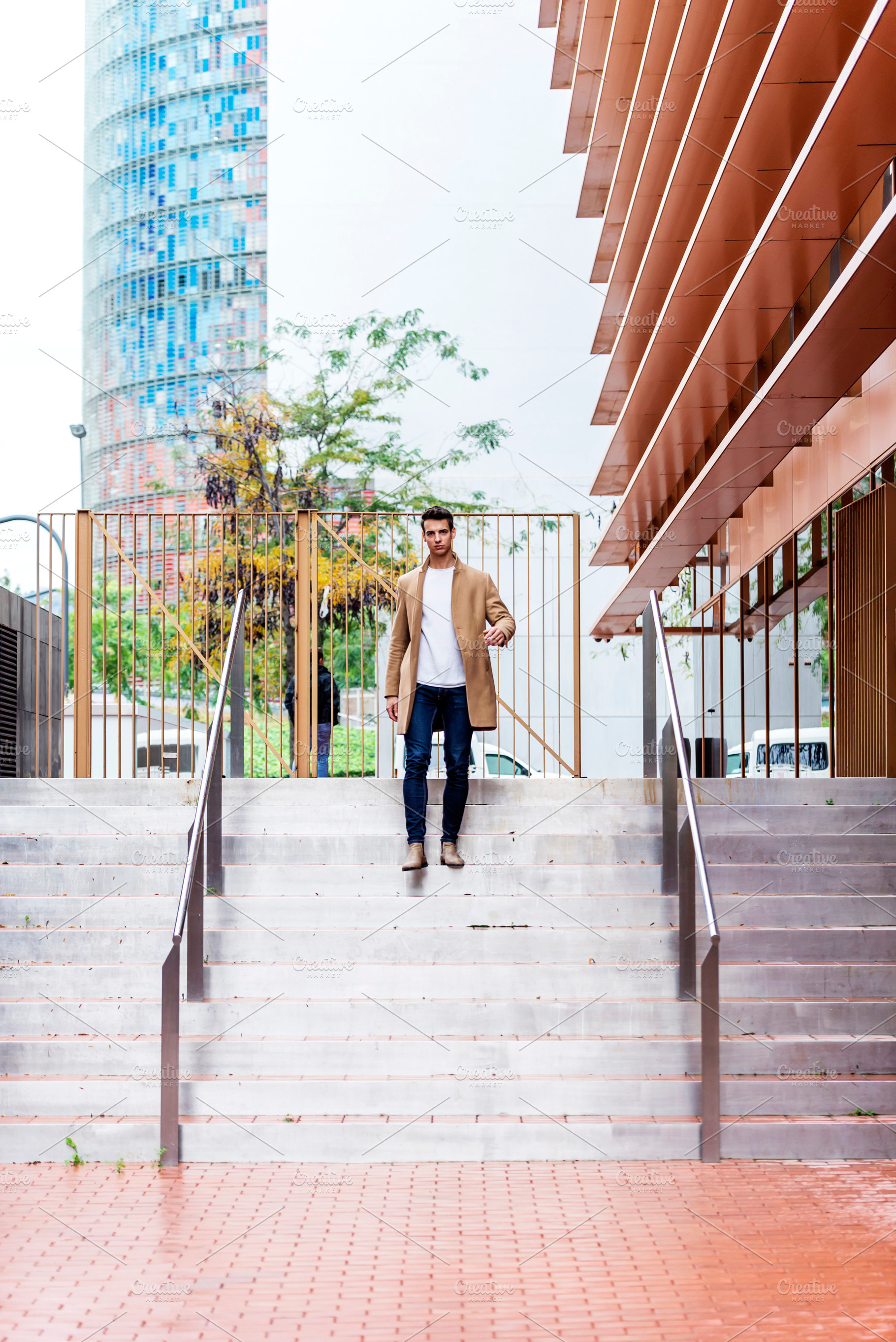 Man walking down stairs in modern city architecture, a Person Photo by RF Images