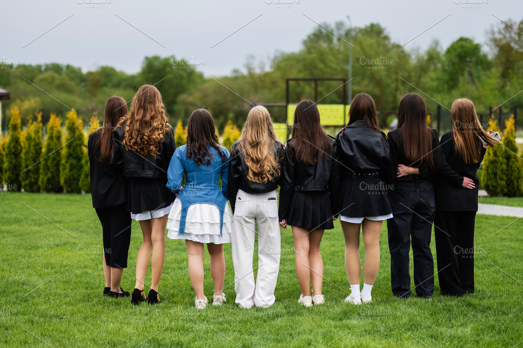 Group of girl friends enjoying an outdoor gathering on a green lawn, a Photo by AS photostudio