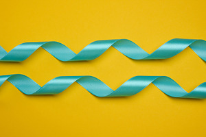 Blue satin ribbon, curved into a wave, centered on a yellow back, a Holiday Photo by ndanko