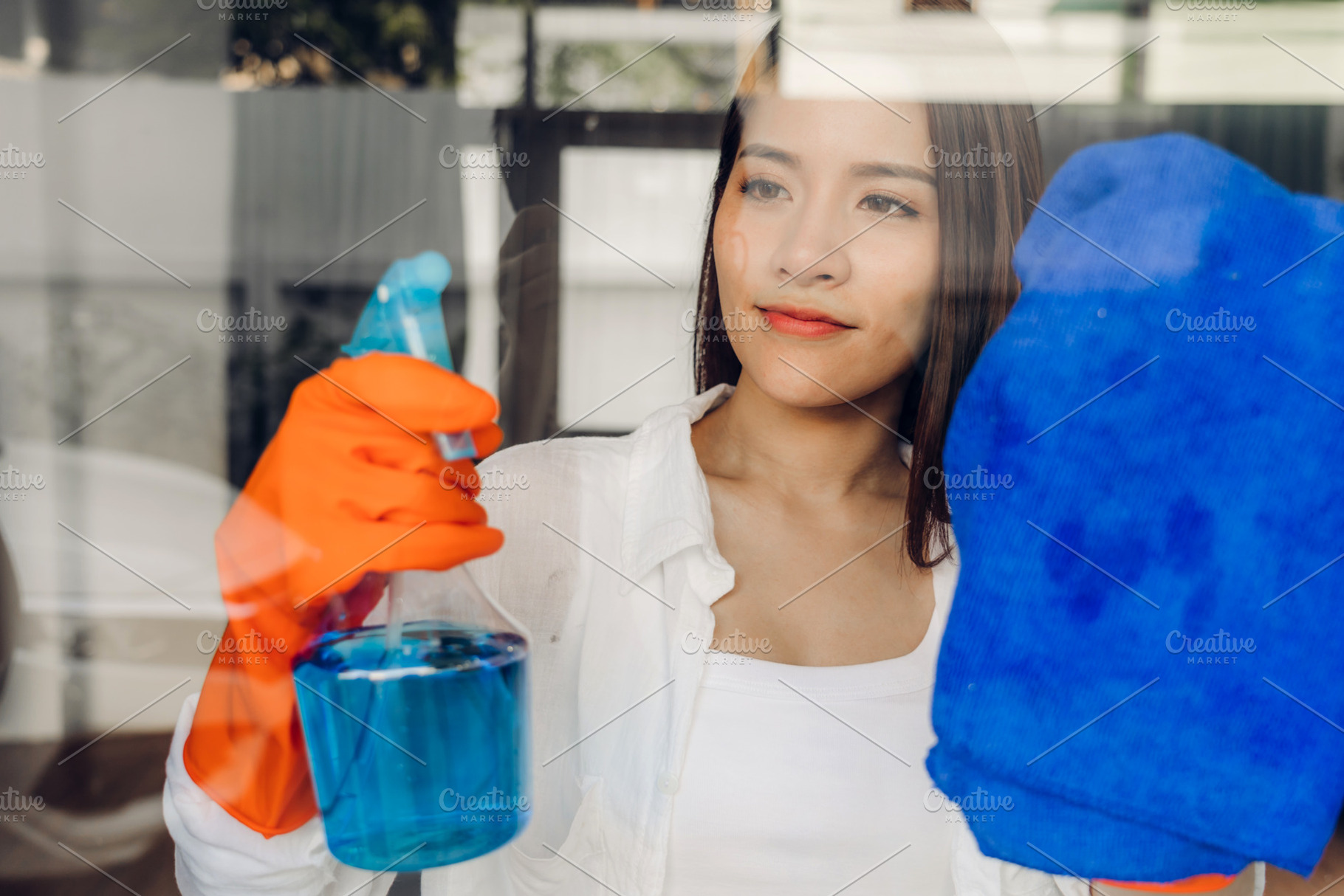 Young asian woman in protective gloves using a spray and rag whi, a Person Photo by Art_Photo