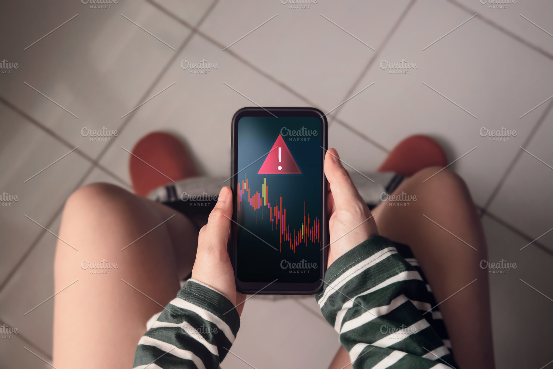 Person sitting in toilet with smartphone showing red falling gra, a Photo by salmon.black