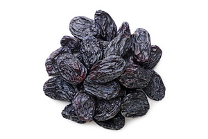 Pile of black raisins on a white, a Food & Drink Photo by innakreativ