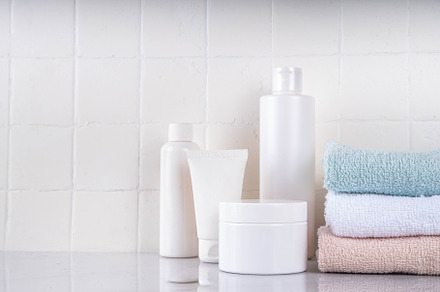 Stack clean bath towels with with cosmetics bottles, a Health & Medical Photo by Rimma