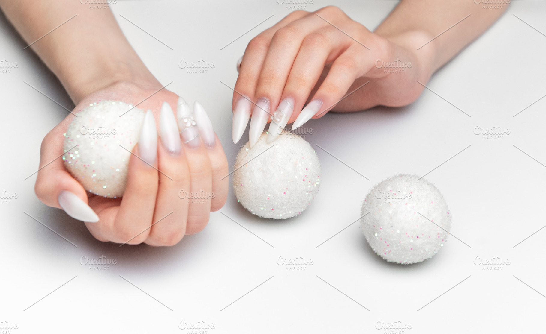 Woman hands holding sparkling christmas ornaments with long nail, a Beauty & Fashion Photo by Olena Rudo