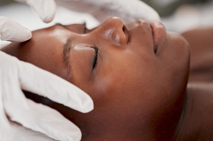Massage, facial and relax with black woman in spa for holistic treatment, beauty and skincare. Peace, luxury and zen with girl customer in salon for cosmetology, wellness and physical therapy, a Photo by Peopleimages.com