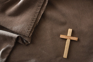 Wooden Cross on Brown Fabric Background, a Holiday Photo by Davizro's Market